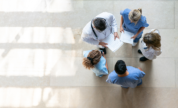 Overhead view of doctors and nurses standing in an office